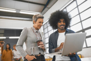 Man displaying work on a tablet to manager