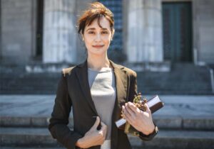 Smartly dressed women stands outside Law Court