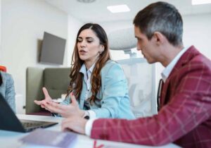 A male and female probation officers discuss a case