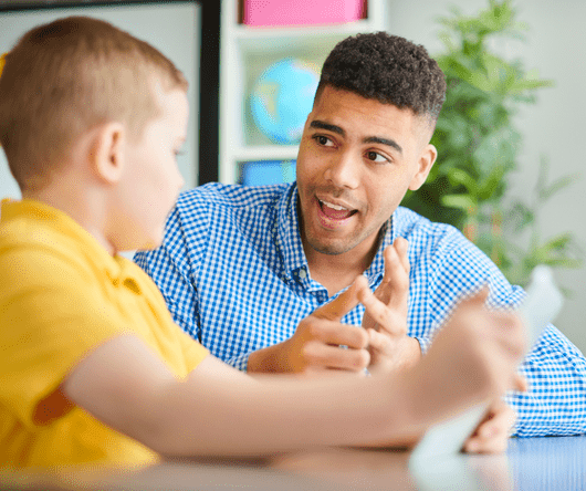 A PGCE teacher is talking to a young pupil