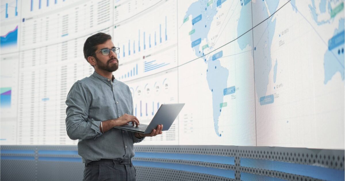 man holding laptop working careers in international business