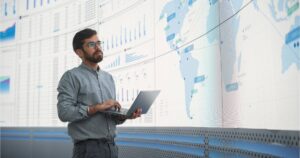 man holding laptop working careers in international business