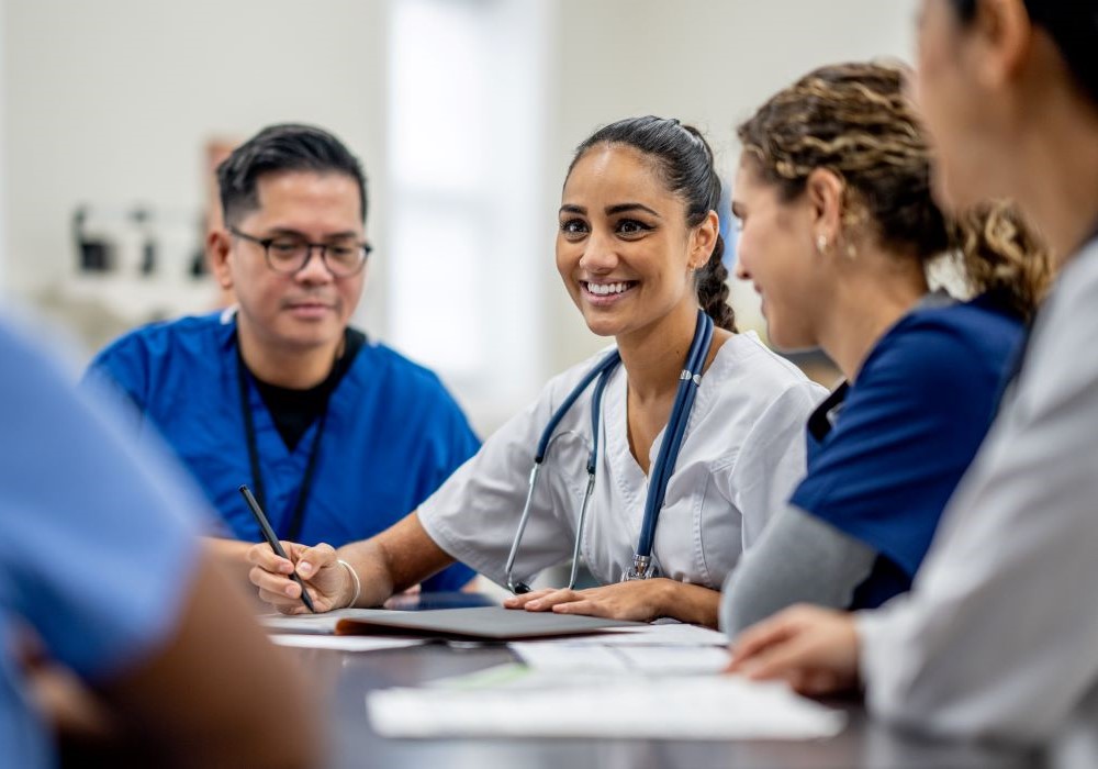 Medical staff are in discussion round a table