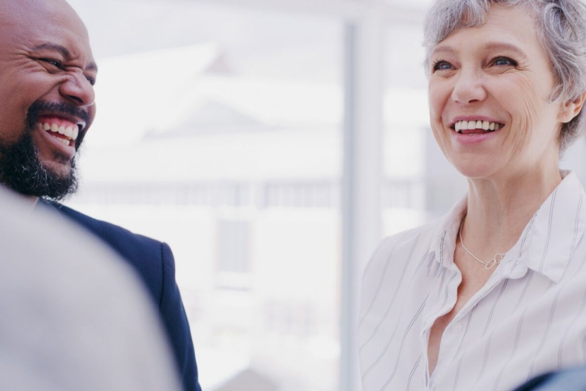 emotional intelligence in the workplace: female and male colleagues smiling