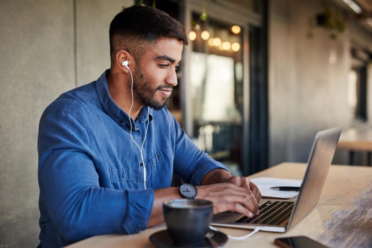 man working on laptop - stay motivated studying online blog