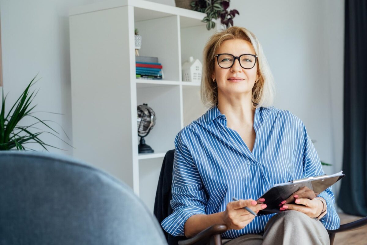 switching careers to psychology blog female psychologist sitting facing camera