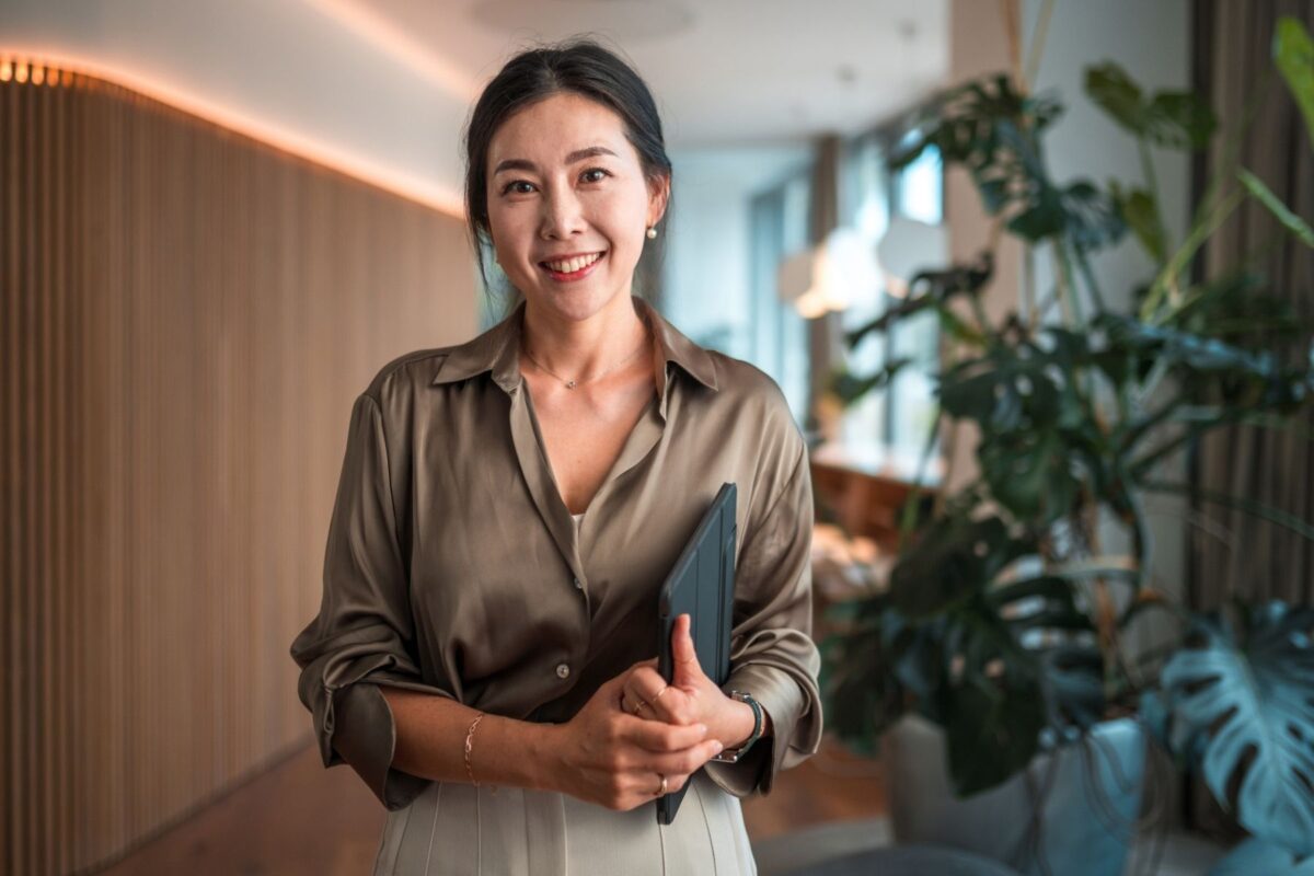 professional woman standing facing camera in her workplace career change at 40