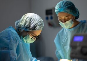 An oncoplastic breast surgeon is at work in an operating theatre