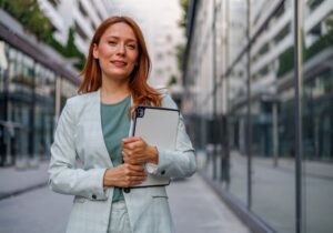 Digital Transformation Business woman standing in a city with a tablet.