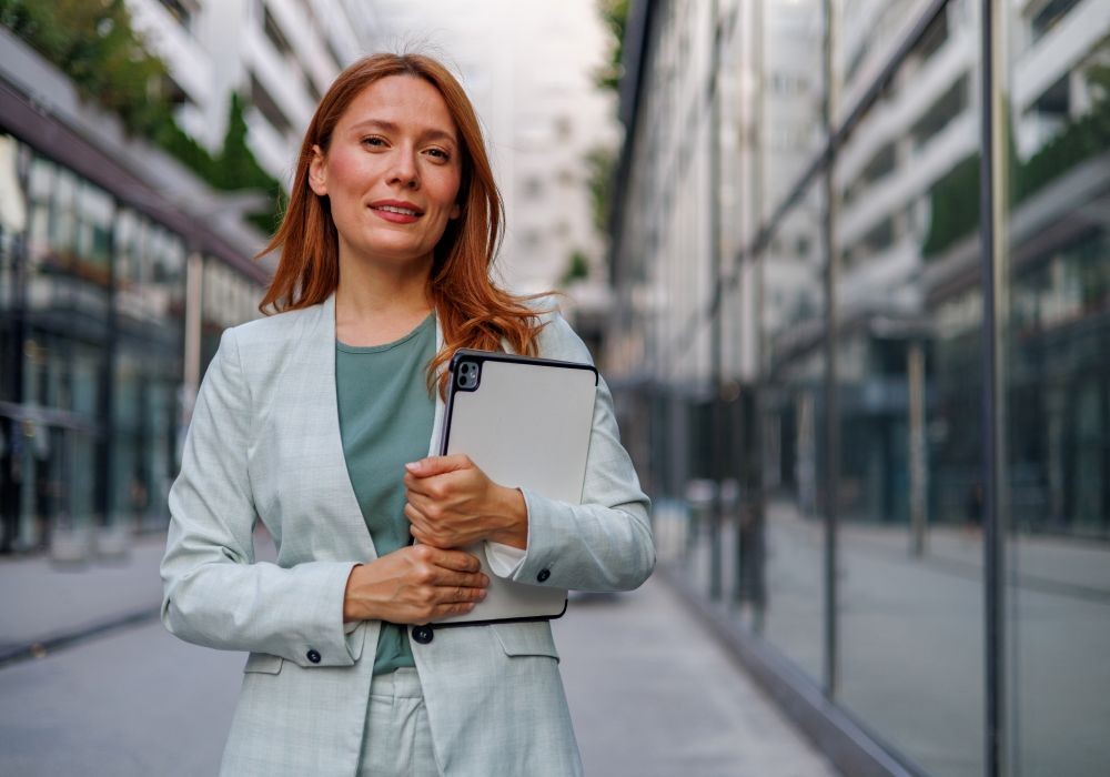 Digital Transformation Business woman standing in a city with a tablet.