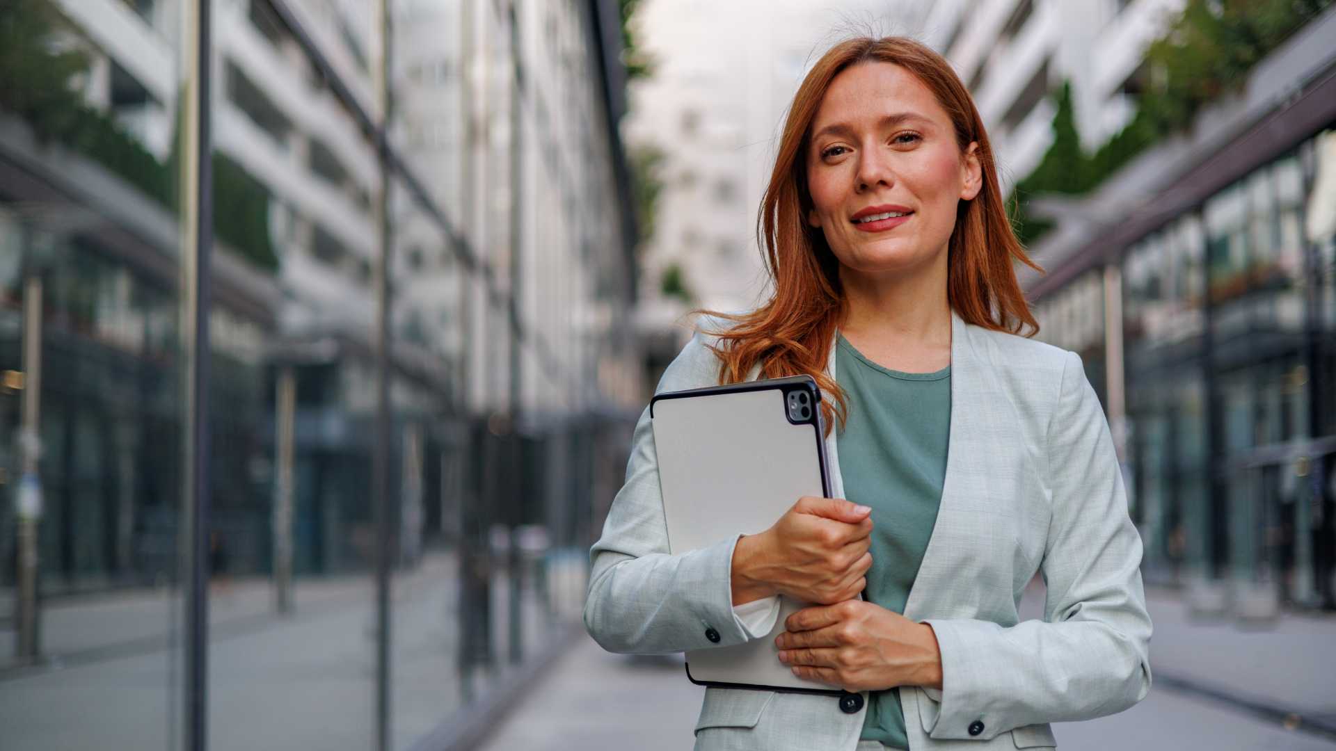 Digital Transformation Business woman standing in a city with a tablet.