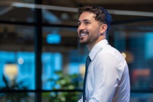 image of male business professional smiling and looking into the distance for blog what can I do with a business degree