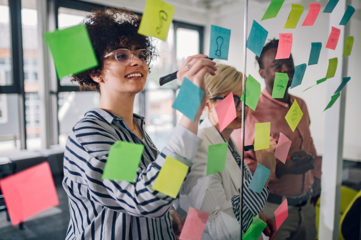 team of professionals jotting ideas on post-it notes - image for What are transferable skills and why they matter in the workplace? blog