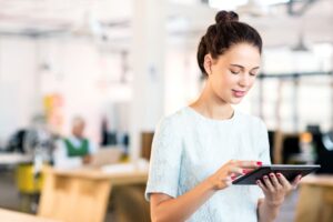 professional development plan blog: woman in office looking at her tablet